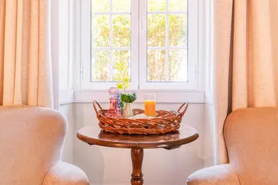 a basket on a table in front of a window at Quinta da Moscadinha in Camacha