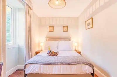 a bedroom with a bed with a bowl of fruit on it at Quinta da Moscadinha in Camacha