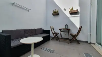 a living room with a couch and a table at Beautiful Studio With Patio Carrapateira in Carrapateira