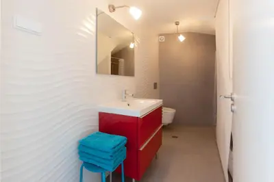 a bathroom with a red sink and a mirror at Beautiful Studio With Patio Carrapateira in Carrapateira