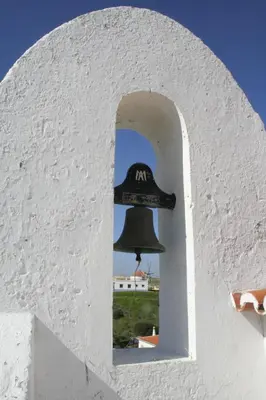 a bell sticking out of a white wall at Beautiful Studio With Patio Carrapateira in Carrapateira