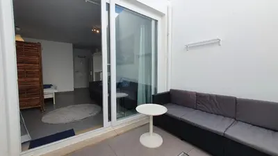 a living room with a couch and a table at Beautiful Studio With Patio Carrapateira in Carrapateira