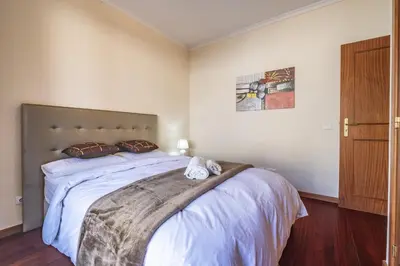 a bedroom with a large bed with white sheets at Casa Blanca II in Funchal