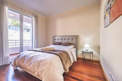 a bedroom with a large bed and a window at Casa Blanca II in Funchal