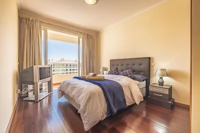 a bedroom with a bed and a tv and a window at Casa Blanca II in Funchal