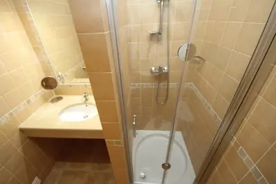 a bathroom with a shower and a sink at Acácias, spacious apartment with sea view in Luz