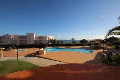 a view of a swimming pool with buildings in the background at Acácias, spacious apartment with sea view in Luz