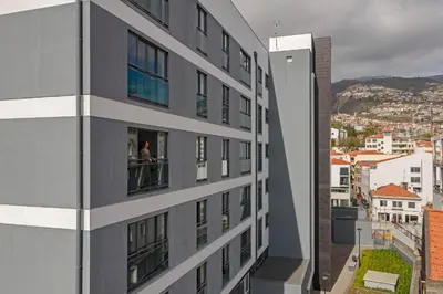 a woman looking out of a window of a building at Santa Luzia I by An Island Apart in Funchal
