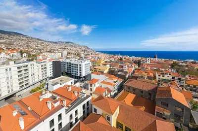 an aerial view of a city with buildings and the ocean at Santa Luzia I by An Island Apart in Funchal