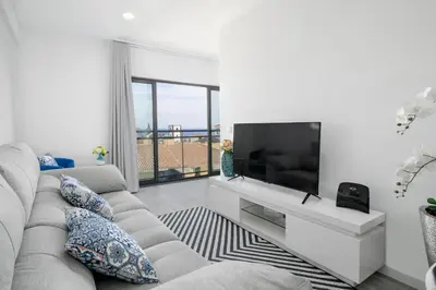 a living room with a couch and a flat screen tv at Santa Luzia I by An Island Apart in Funchal