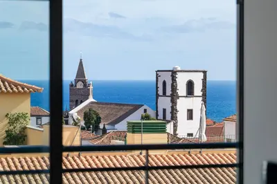 a view of a church from a window at Santa Luzia I by An Island Apart in Funchal