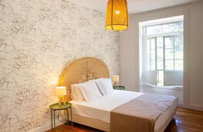 a bedroom with a large bed with a wall mural at Casa do Bago in São Vicente