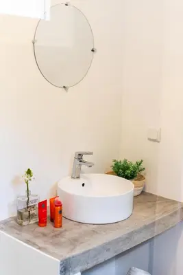 a bathroom with a white sink and a mirror at Casa do Bago in São Vicente