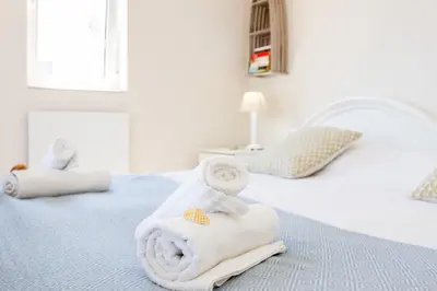 a bedroom with a bed with towels on it at Mariners (5) - Bright and stylish apartment - walk to the beach in Luz