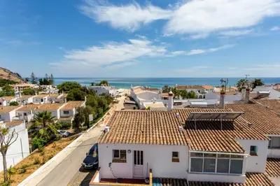 a view of a town with houses and the ocean at Mariners (2) - Bright and stylish apartment - walk to the beach in Luz