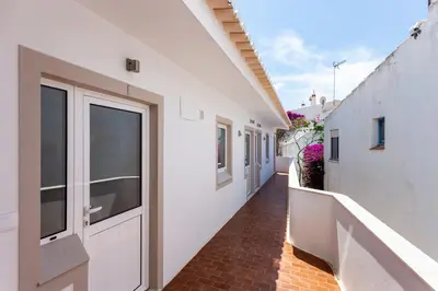 a hallway of a white building with a door at Mariners (2) - Bright and stylish apartment - walk to the beach in Luz