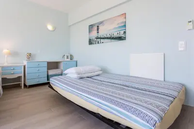 a bedroom with a bed and a desk and a painting at Mariners (2) - Bright and stylish apartment - walk to the beach in Luz