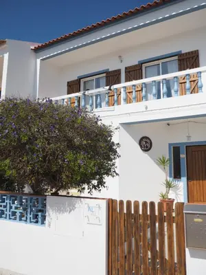 a white house with a wooden fence at Casa Boa Onda in Sagres