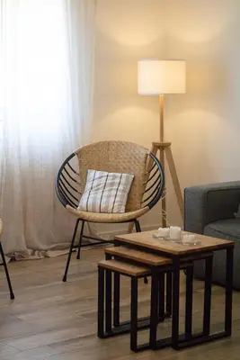 a living room with a chair and a table at Casa Boa Onda in Sagres