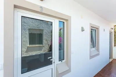 a door with a window in a house at Mariners (3) - Bright and stylish apartment - 2 minute walk to the beach in Luz