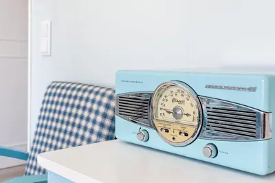 a blue radio sitting on top of a table at Mariners (3) - Bright and stylish apartment - 2 minute walk to the beach in Luz