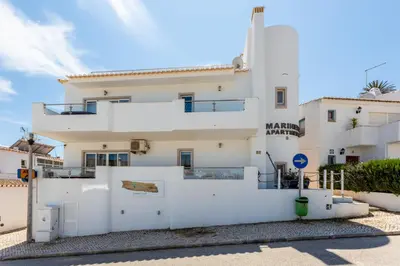 a white house with a white fence in front of it at Mariners (3) - Bright and stylish apartment - 2 minute walk to the beach in Luz