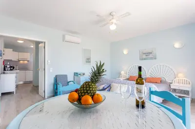 a room with a table with a bowl of fruit on it at Mariners (3) - Bright and stylish apartment - 2 minute walk to the beach in Luz