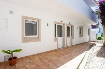 a room with white walls and windows and a potted plant at Mariners (4) - Bright and stylish apartment in Luz