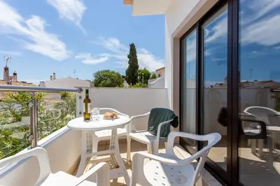 a balcony with a white table and chairs at Mariners (4) - Bright and stylish apartment in Luz