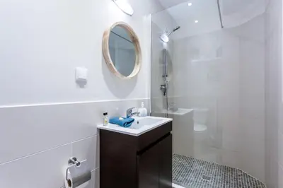 a white bathroom with a sink and a mirror at Mariners (4) - Bright and stylish apartment in Luz