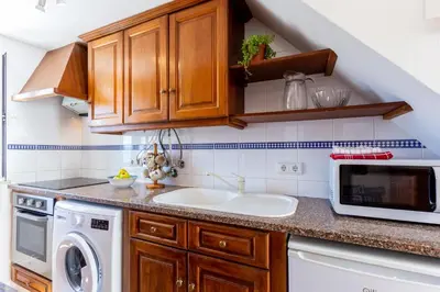 a kitchen with a sink and a microwave at Casa Pedro Burgau in Burgau