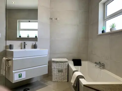 a bathroom with a sink and a bath tub and a sink at Monte Lemos 29 in Luz
