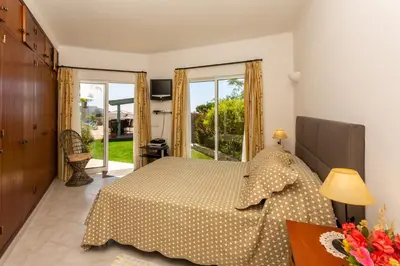 a bedroom with a bed and a large window at Monte Lemos 29 in Luz