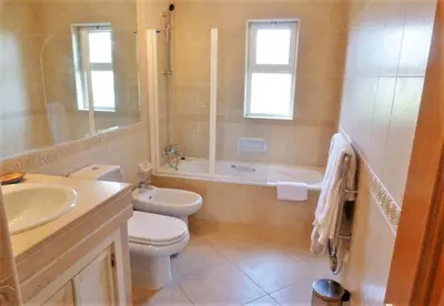 a bathroom with a toilet and a sink and a shower at Boavista 73 in Lagos
