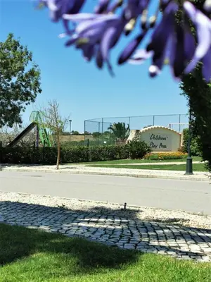 a bird sitting on the grass next to a playground at Boavista 73 in Lagos