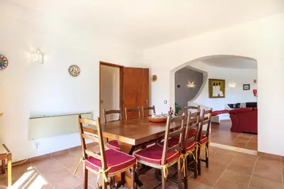 a dining room with a wooden table and chairs at Villa Oceanis in Luz