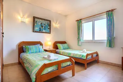 a bedroom with two beds and a window at Villa Oceanis in Luz