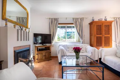 a living room with a white couch and a fireplace at Villa Goshen in Lagos