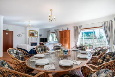 a dining room with a table and chairs at Villa Goshen in Lagos