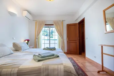 a bedroom with two beds and a window at Villa Goshen in Lagos