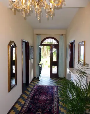 a hallway with a chandelier and an entry way at Villa Erika Madeira in Caniço