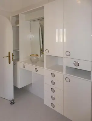 a white dressing room with white cabinets and a mirror at Villa Erika Madeira in Caniço