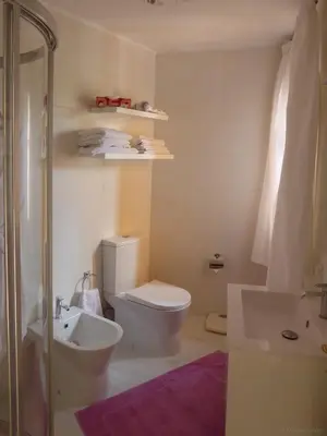a bathroom with a toilet and a sink at Villa Erika Madeira in Caniço