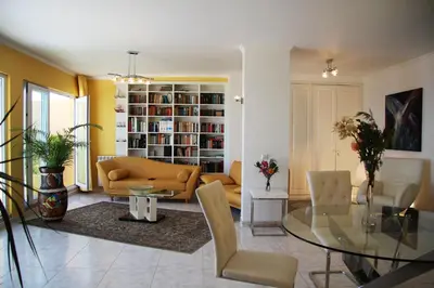 a living room with a couch and a glass table at Villa Erika Madeira -Penthaus- in Caniço