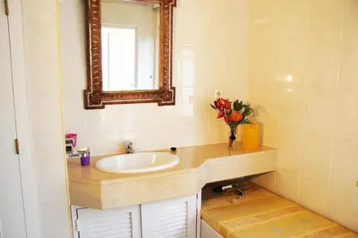 a bathroom with a sink and a mirror at Villa Erika Madeira -Penthaus- in Caniço
