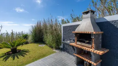 a outdoor oven in a yard with a garden at Casa da Felicidade by LovelyStay in Prazeres