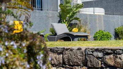 a piano sitting in a yard next to a stone wall at Casa da Felicidade by LovelyStay in Prazeres