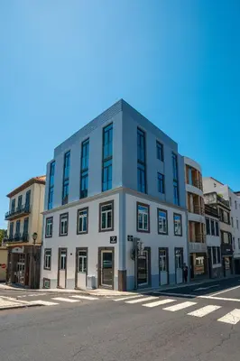 a blue and white building on the corner of a street at Zarco Apartments by Mercado Funchal in Funchal