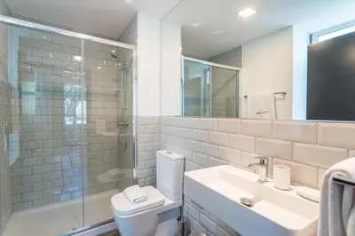 a bathroom with a toilet and a sink and a shower at Zarco Apartments by Mercado Funchal in Funchal