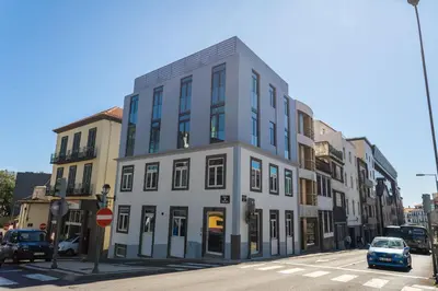 a tall white building on a city street at Zarco Apartments by Mercado Funchal in Funchal